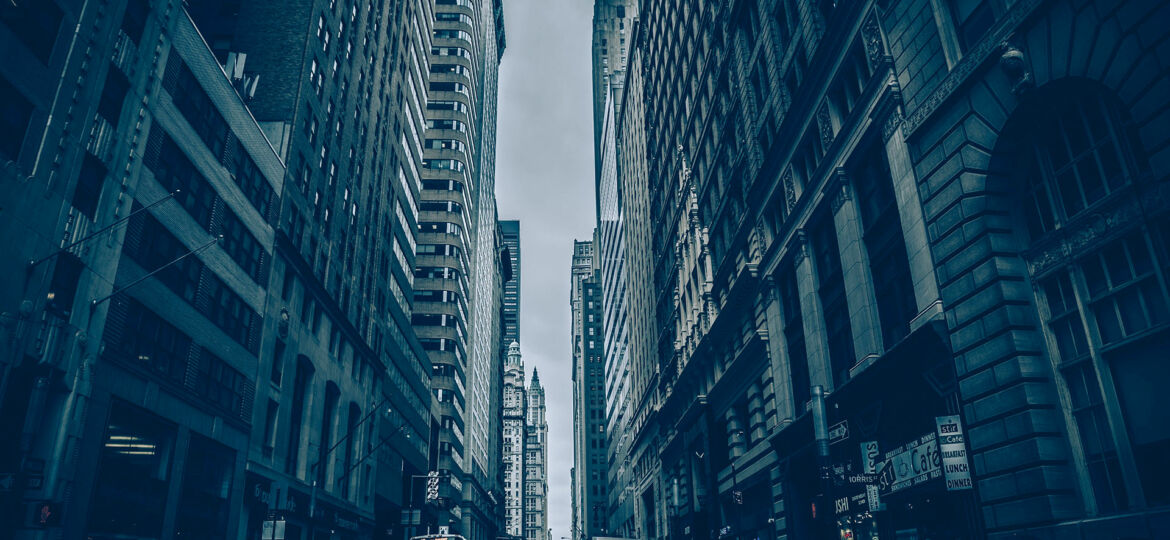 Tall buildings lining a narrow city street.